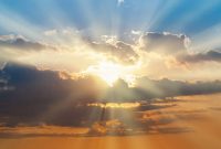 Blue and orange sunset sky with rays of sun. Natural landscape for background