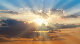 Blue and orange sunset sky with rays of sun. Natural landscape for background