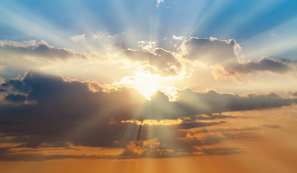 Blue and orange sunset sky with rays of sun. Natural landscape for background
